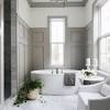 Small half bath with vertical wall paneling. 1
