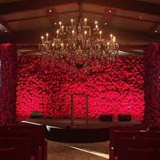 A Stunning Backdrop Of Red Roses By Marksgarden Red Wedding Decorations Wedding Stage Decorations Red Rose Wedding