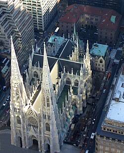 Interior view of St. Patrick's Cathedral showing the high altar, vaulted ceilings, and stained glass windows
