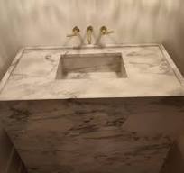 This custom designed marble vanity has been installed. It ...