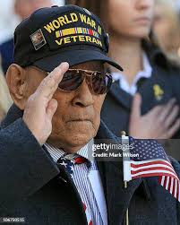 U.S. Army Capt. Brendan Rowe kneels at the grave site of his friend... News  Photo