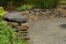 Using construction adhesive, secure your capstones and create the top layer of your retaining wall. 21 Practical Retaining Wall Ideas For Extra Curb Appeal Lawnstarter