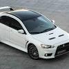 Mitsubishi lancer sports an aerodynamic structure with bold looking black front grille and sidelines. 1