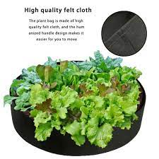 A part of a garden where flowers are planted 2. 50 Gallons Fabric Raised Garden Bed Round Planting Container Grow Bags Breathable Felt Fabric Planter Plants For Raised Beds Bedding Plants Raised Planter Beds