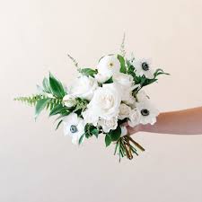 Once you have it all planned, put the bouquets together with floral tape and ribbon. Garden White Bridesmaid Bouquet Mum S Weddings