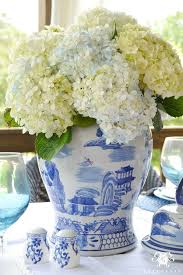 Welcome guests to your home with a collection of ginger jars on your entry way table filled with fresh hydrangeas in a coordinating blue and white color palette. A Patriotic Outdoor Table For The Fourth Of July White Ginger Jars Ginger Jars Blue And White