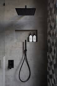 Grey bathroom with black hardware. Matte Black Accents Add Sophistication To This Grey And White Bathroom