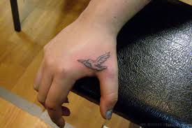 It was a small black ink tattoo located on the underside of the left arm. 43 Fancy Birds Tattoos On Hand