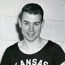 Thane Baker is the most decorated Olympic Track and Field athlete in  K-State history, winning a silver medal in Helsinki in 1952, and a gold,  silver and bronze in Melbourne in 1956.
