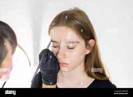 Threading eyebrows hi-res stock photography and images