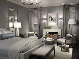 A shiny and elegant bedroom with grey walls, white paneling, a graphite grey bed, a shiny chandelier, gold frame nightstands and mustard bedding. Feel Elegant With Gray Bedroom Beautiful Gray Bedroom Wonderful Gray Bedroom Design By Bertadeluca Luxurious Bedrooms Bedroom Design Home Bedroom