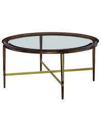Crafted with a metal frame finished in gold, this table creates clean lines with a simple round shape and tempered glass top. Round Glass Coffee Table From Our Modern Dakota Collection