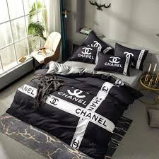 Two sheepskin stools with brass legs sit on a white and gray geometric area rug beneath an andy warhol chanel art piece hung on from a wall covered in. Chanel Duvet Set Cincy Sales