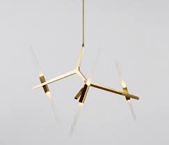 Crafted from metal, it features a circular ceiling mount, a hanging chain, and six lights sticking out from rods at all angles for a modern and linear look. Agnes Chandelier 6 Lights Brass Architonic