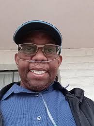 Need to have the oxygen tube removed and a better background for an  obituary photo, please.