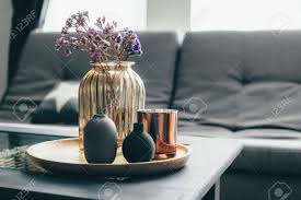 Maybe you would like to learn more about one of these? Home Interior Decor In Gray And Brown Colors Glass Jar With Dried Flowers Vase And Candle On The Wooden Tray On The Coffee Table Over Sofa Living Room Decoration Stock Photo Picture