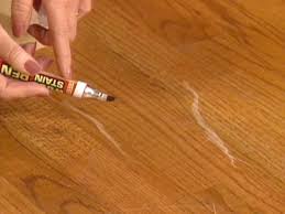 The floor in the kitchen has some of the shiny parts flaking off, but the wood itself doesn't appear to be damaged too much. How To Touch Up Wood Floors How Tos Diy