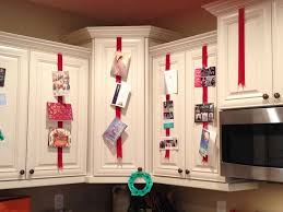 Christmas Ribbons On Cabinet Idea To Display Christmas Cards Tape Red Ribbon To Inside Cabinet Christmas Card Display Holiday Card Display Christmas Deco