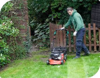 Gardener shaping a boundary hedge in Thamesmead