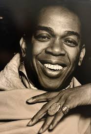 Geoffrey Holder. Trinidadian-American actor, dancer, musician, director,  choreographer, and artist. He played the villainous Baron Samedi in the  Bond film Live and Let Die. He also carried out advertising work as the