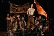 This shot includes a view of the floor as a muddy river flowing. Urinetown Music Theatre International