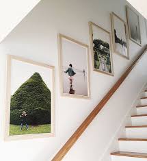 Check out our stairs wall decor selection for the very best in unique or custom, handmade pieces from our home & living shops. Joanna Goddard On Instagram How Beautiful Are These Family Photos Going Up The Stairs One Year We Suf Staircase Wall Decor Stair Wall Decor Staircase Wall