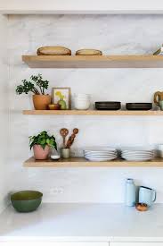 White oak floating shelves kitchen. Home Tour Lauren S Warm And Modern Austin Kitchen The Effortless Chic Warm Modern Kitchen Modern Kitchen Open Modern Kitchen Open Shelving