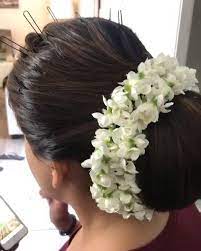 What A Beautiful Large Low Bun With Real Flower Gajra Care However Should Be Taken Before Adopting Such Hairs Indian Bun Hairstyles Bun Hairstyles Bridal Updo