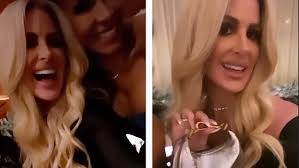 Kim Zolciak flashes her chest with reality TV producer Troy VanderHeyden