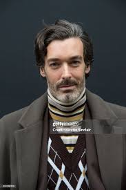 Model Richard Biedul wears a Reiss coat, Daks London sleeveless... News  Photo
