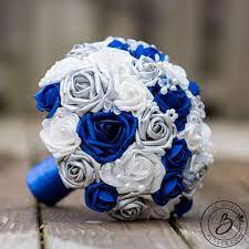 I wanted royal blue, silver, and white, but i was told that the flowers would probably look black in the pictures and it is hard to find royal blue items. Shiny Blue And New Royal Blue Silver And White Round Wedding Bouquet With Crystals And Pear Blue Silver Weddings Blue Wedding Bouquet Blue Wedding Flowers