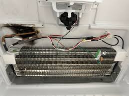 What could have caused the burn marks near the coil area of a Whirlpool  Gladiator refrigerator?