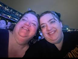 Not the best picture of either of us but I love the story behind it. We  both love going to concerts and and this Guns N' Roses one was a first for  both of us. Outside in the down pouring rain……. One of the best night ever.  Siblings: Melissa '93 and Karen '86