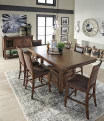 A counter set is an ideal dining set solution for taller individuals or simply those who wish to have a little more leg room while enjoying their meals. Royard Counter Height Dining Room Table By Ashley Furniture Nis987058322 Missouri Furniture