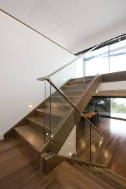 Modern Staircase With A Glass Balustrade And Wooden Handrails For A Contrast Staircase Design Modern Stairs Staircase Handrail