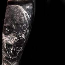 50 Realistic Wolf Tattoo Designs For Men Canine Ink Ideas Wolf Tattoo Designs Realistic Wolf Tattoo Design Wolf Tattoo