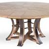 An extension is revealed at the center of the table and it has a black finish that contrasts with the initial. 1
