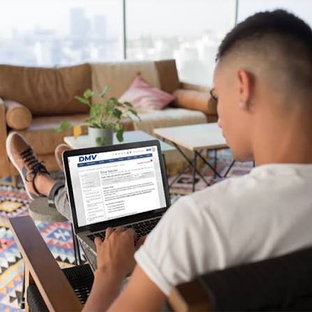 Student taking a computerized DMV driver knowledge test inside an official state testing workstation, Secure DMV online driving test service | IDEMIA. how to get a driver's license in the US