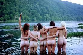 Young Nude Girl Friends Having Fun And Hugging Outside And Standing In A  River