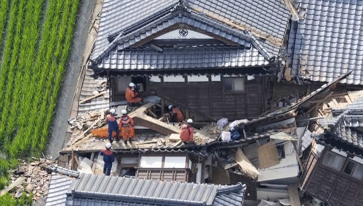 Emergency rescue workers conducting a search operation amidst debris following the 7.1 magnitude earthquake in Japan.