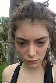 Lorde is all smiles as she arrives at LAX with her father