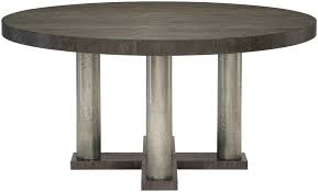 Its clear glass top allows the dramatic cylindrical metal base to be fully visible. Round Dining Table Bernhardt