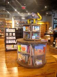 Spools Topped With A Rusted Metal Sculpture Totally Not A Chain Store Bookstore Cafe Bookstore Design Storefront Design