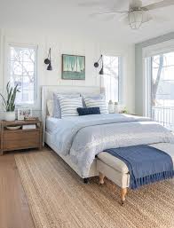 Whether used as inspiration for your bedroom's decor or as a focal point over your bed, wall art can infuse personality into your space. White And Blue Lake House Master Bedroom The Lilypad Cottage White Upholstered Bed Remodel Bedroom Bedroom Design
