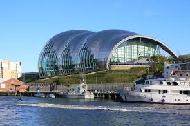 Gateshead is a town in tyne and wear in the northeast of england, situated south of newcastle upon tyne on the banks of the river tyne. Sage Gateshead Wikipedia