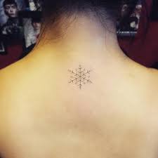 You can go for one that has minimal line work and plain black. Snowflake Tattoo On The Upper Back