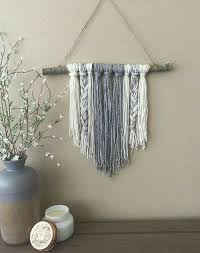 Very Simple Yarn Tied To A Stick Creates An Attractive And Inexpensive Wall Hanging Wall Hanging Diy Yarn Wall Hanging Yarn Wall Art