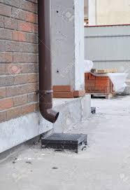 It can be stretched and angled as needed, and connects. Install Roof Gutter Drain Downspout Pipe On Brick House Wall Stock Photo Picture And Royalty Free Image Image 107592224