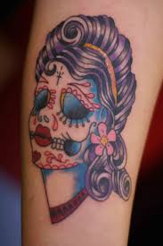This tattoo represents the individual between the four walls of the prison cell (un homme entre quatre murs—a man between four walls); Sugar Skull Tattoo