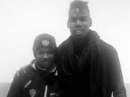 Manchester united's paul pogba applauds fans while holding a palestinian flag with amad diallo during a lap of appreciation after the match . Pogba And Amad Waving The Palestine Flag Soccer